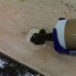 Adding Silicone II roofing caulk to the hole